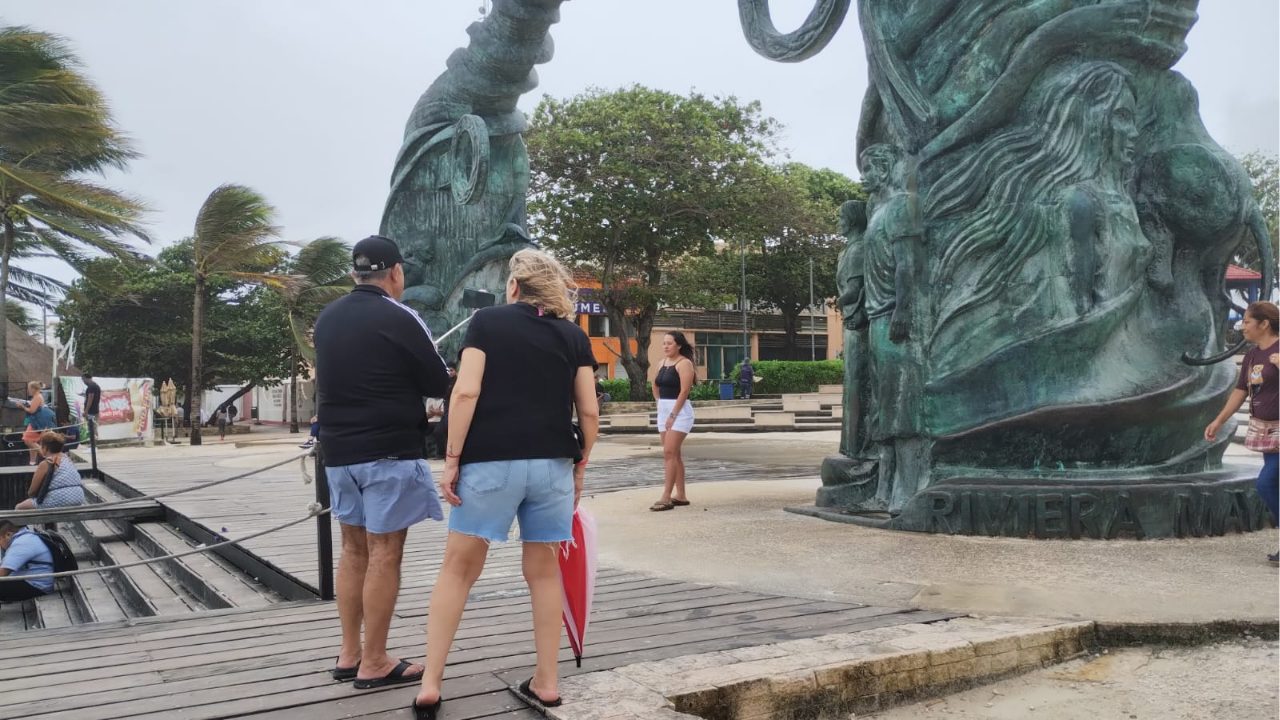 Turistas en Playa del Carmen disfrutan de las playas del destino durante la temporada vacacional de verano.